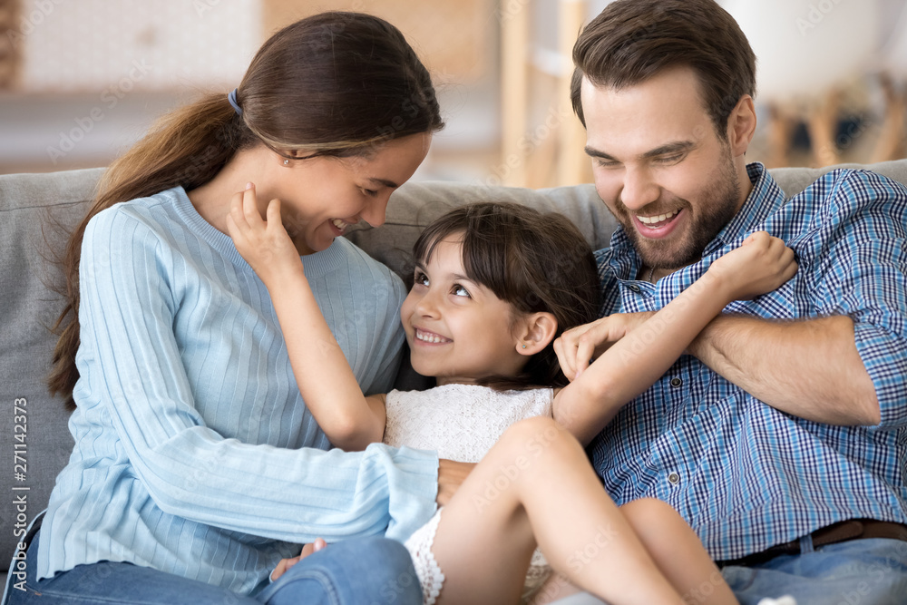Cute little girl have fun relaxing at home with parents Cute little girl have fun relaxing at home with parents