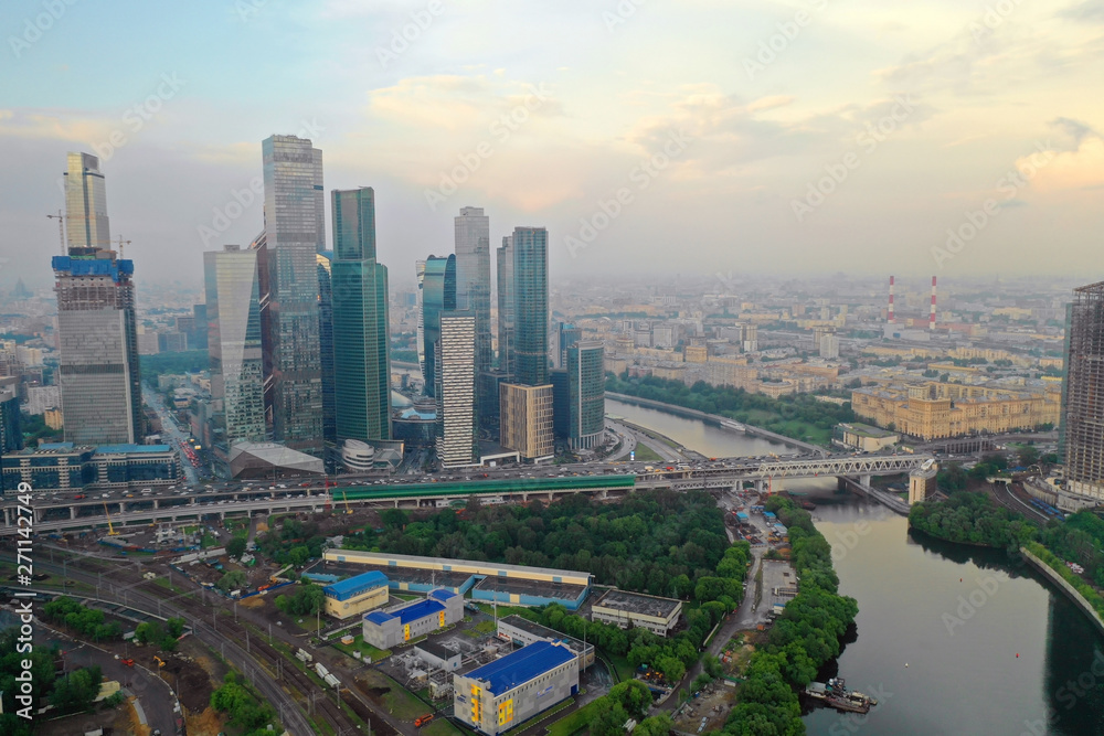 Fototapeta premium Aerial view of the skyscrapers of the business center of Moscow and highway at sunset