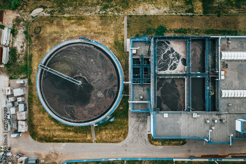 Aerial view of round storage tank in water treatment and cleaning plant