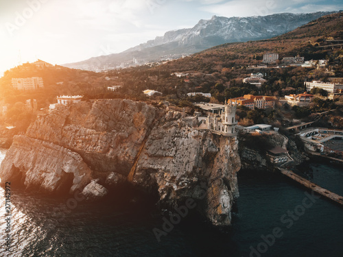 Swallow Nest aerial drone shot, ancient castle on top of mountain cliff near sea Yalta region, Crimea. Beautiful famous palace architecture and amazing nature landscape photo