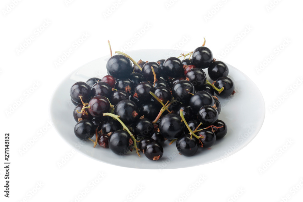 heap of black currants in white plate isolated on white background heap of black currants in white plate isolated on white background