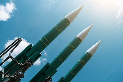 Fototapeta Naklejka Na Ścianę i Meble -  Ballistic missiles on blue sunny sky background, anti aircraft forces, military industry. War and peace concept