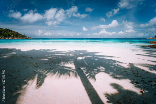 Fototapeta Naklejka Na Ścianę i Meble -  Palm tree shadow on tropical white sand beach wirh blue ocean clouds