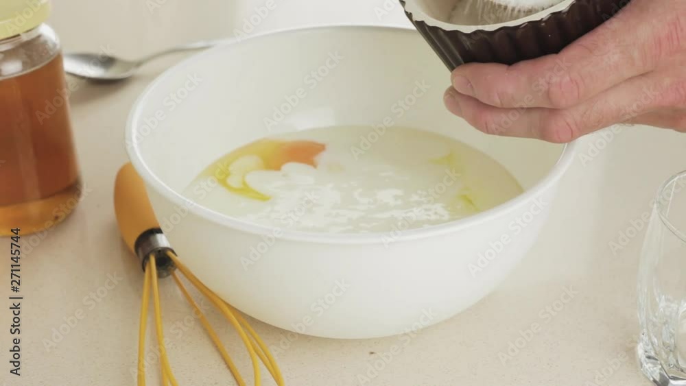 Making dough for pancakes - add a tablespoon of sugar to a white plastic bowl - homemade traditional sweet breakfast step by step - recipe for a simple and nutritious dish Making dough for pancakes - add a tablespoon of sugar to a white plastic bowl - homemade traditional sweet breakfast step by step - recipe for a simple and nutritious dish