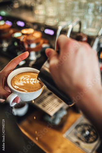 Barista making coffee in coffee shop, cappuccino and latte art. 
