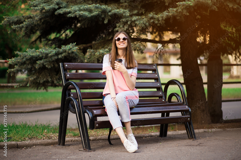 Git in sunglasses sit on the bench and drink coffee