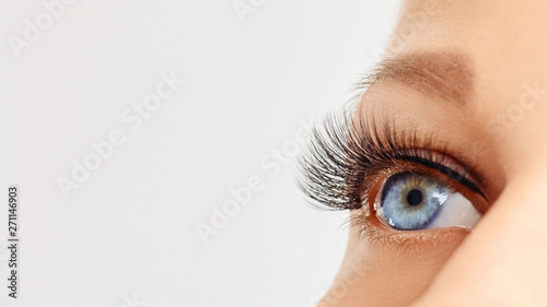 Female eye with extreme long false eye lashes. Eyelash extensions, make-up, cosmetics, beauty photo