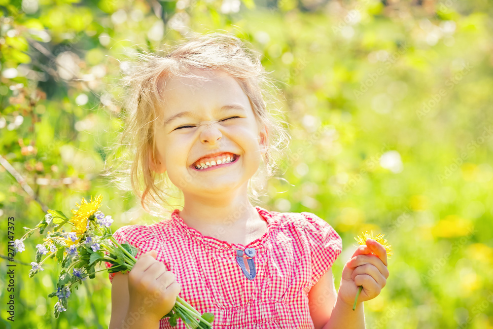 Happy little girl playing with bouquet in sunny park Happy little girl playing with bouquet in sunny park
