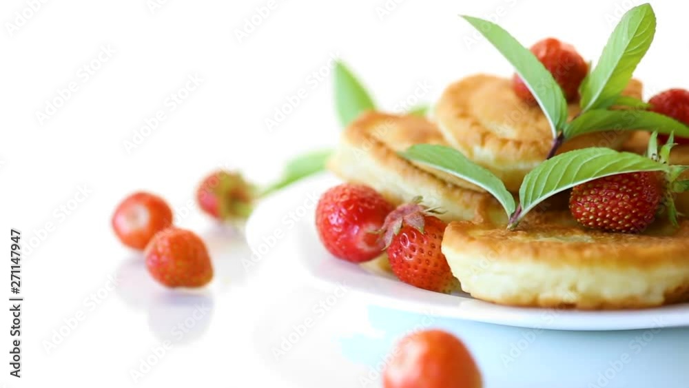 fried sweet pancakes with ripe strawberries in a plate fried sweet pancakes with ripe strawberries in a plate