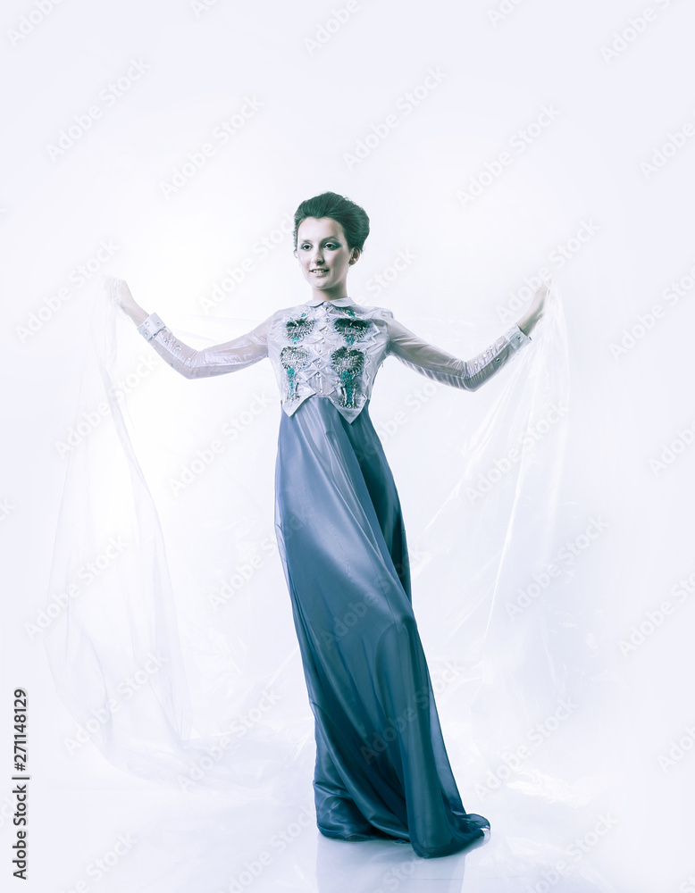 in full growth. beautiful woman model posing in a fashionable evening dress.