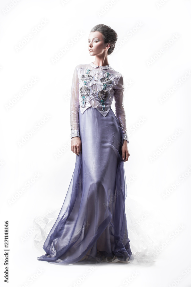 in full growth. glamorous young woman posing in a fashionable evening dress. in full growth. glamorous young woman posing in a fashionable evening dress.