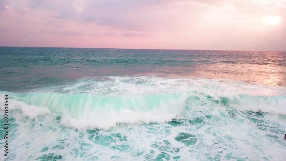 the wave moves to the shore, the surfers go into it the wave moves to the shore, the surfers go into it