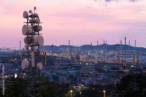 Telecommunication tower with 5G cellular network antenna on industrial zone background
