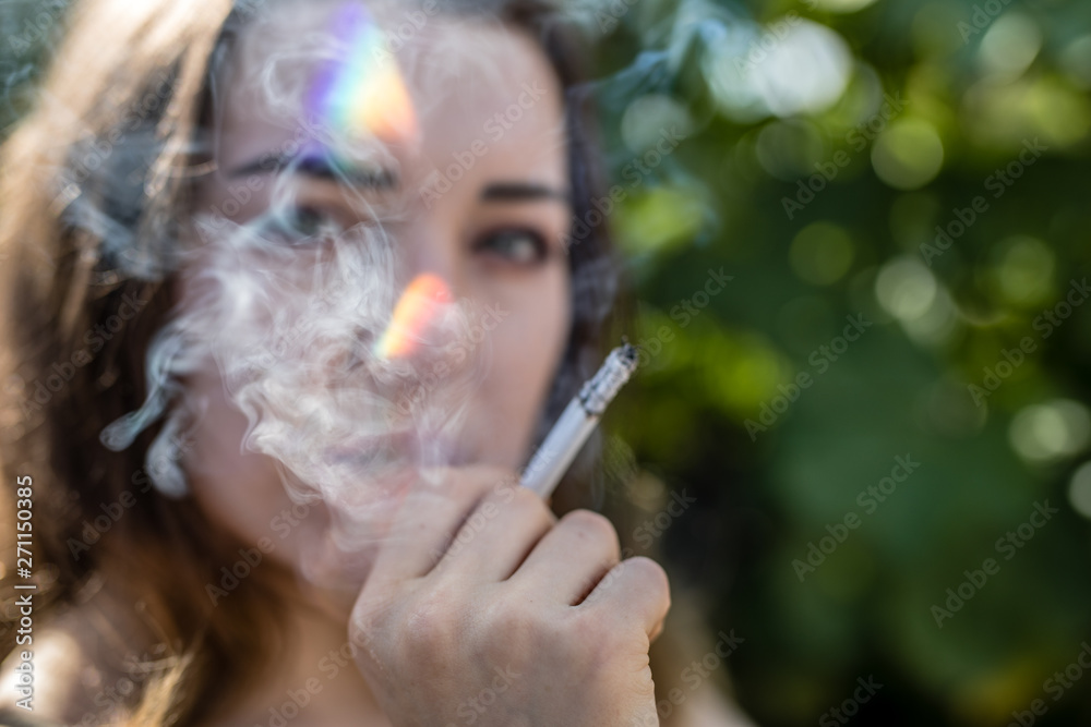 Fototapeta premium girl playing around and smoke a cigarettes in the city berlin by tigerraw