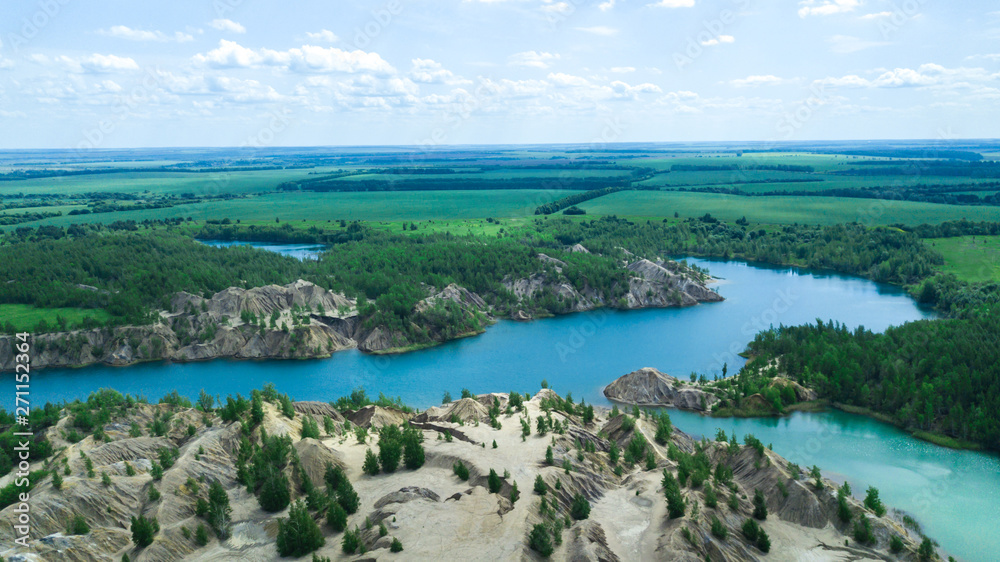 Blue lake. Sand dunes. Green lake. Blue sky and clouds.