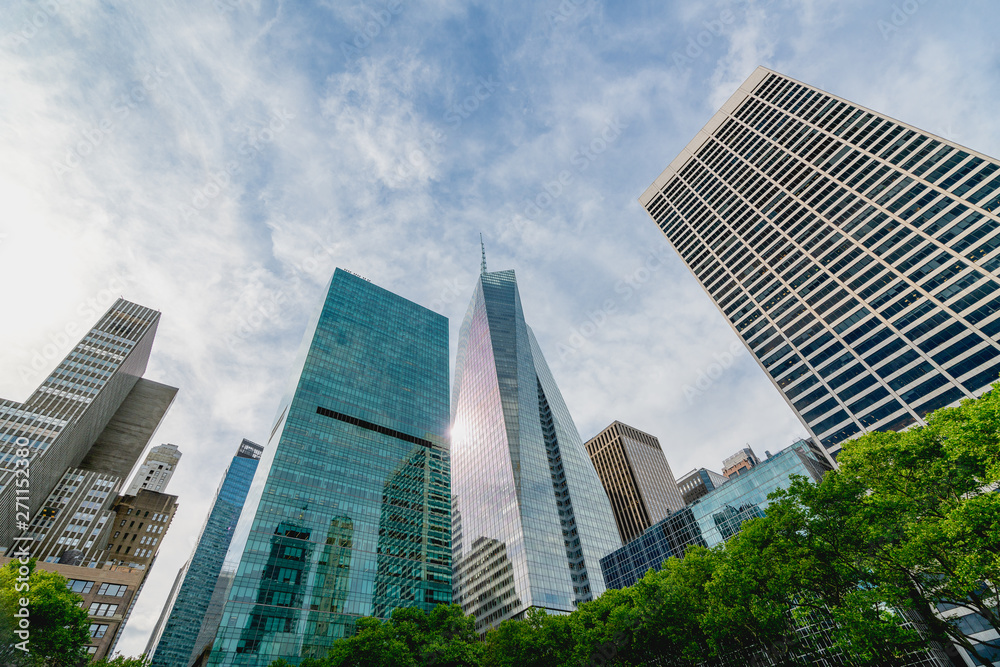 New York City Skyscrapers, Bright Sun, and Beautiful Cloudy Blue Sky New York City Skyscrapers, Bright Sun, and Beautiful Cloudy Blue Sky