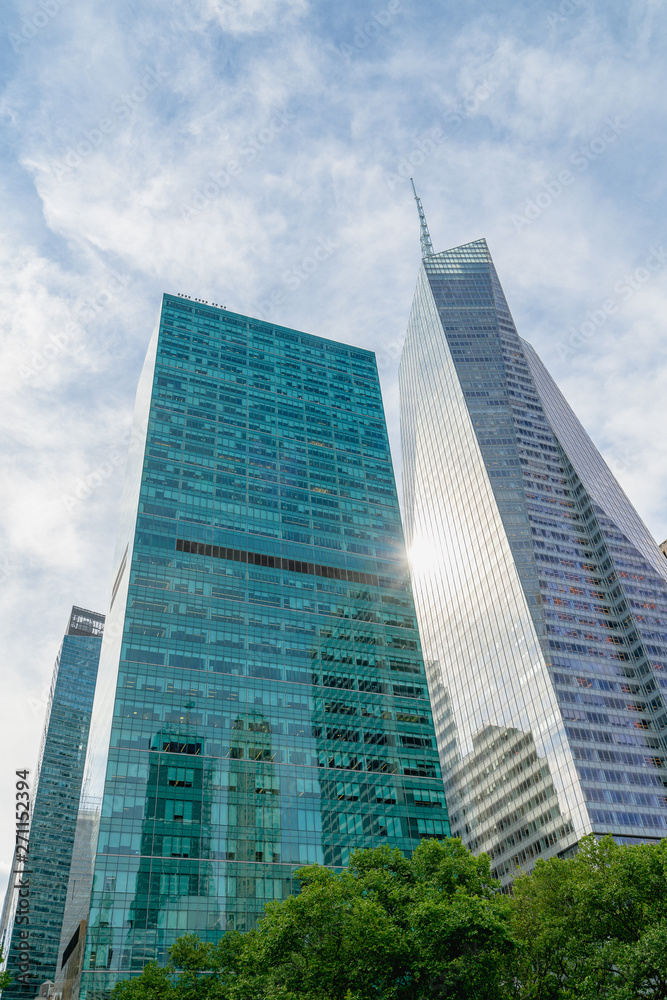 New York City Skyscrapers, Bright Sun, and Beautiful Cloudy Blue Sky