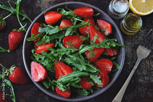 Fresh juicy salad with strawberries and arugula. Vegan diet Healthy food. Fitness salad.