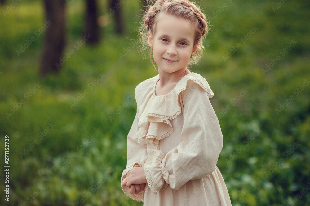 Beautiful cute girls in the garden, enjoying the arrival of spring, dresses in vintage style Beautiful cute girls in the garden, enjoying the arrival of spring, dresses in vintage style