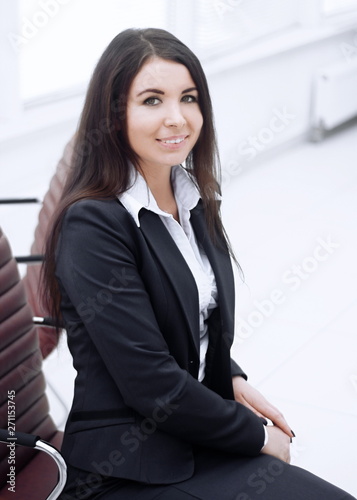 close up. friendly business woman sitting on office couch