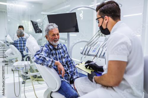 Senior man having dental treatment at dentist s office.