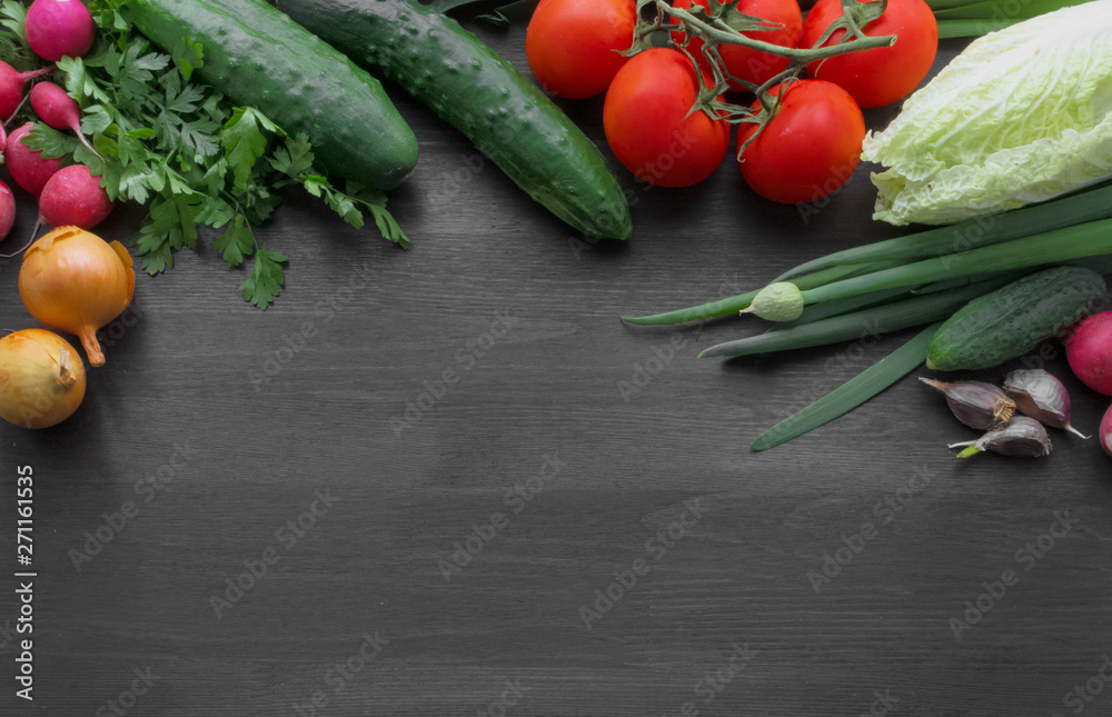 Fresh summer vegetables on a black wooden table Fresh summer vegetables on a black wooden table