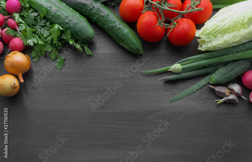 Fresh summer vegetables on a black wooden table