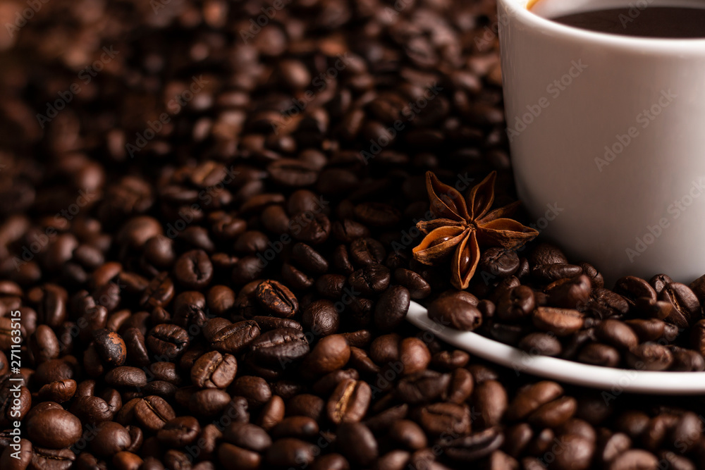 Fototapeta premium Coffee beans with white cup and star anise