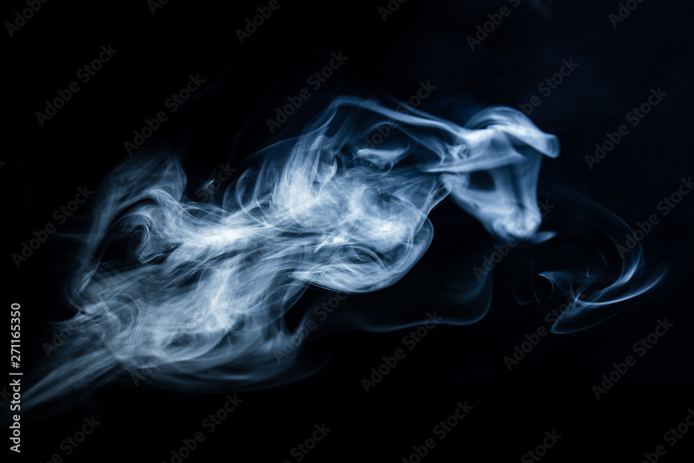 White, blue cigarette smoke on a black background. Stop smoking
