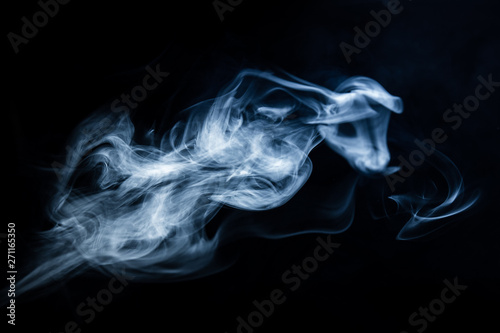 White  blue cigarette smoke on a black background. Stop smoking