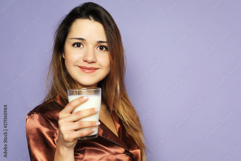 lifestyle and people concept: beautiful girl dressed in pajamas drinking milk lifestyle and people concept: beautiful girl dressed in pajamas drinking milk