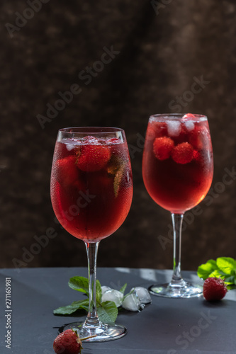 Refreshing drink with strawberries and mint on a table. Perfect for party or hot days.	