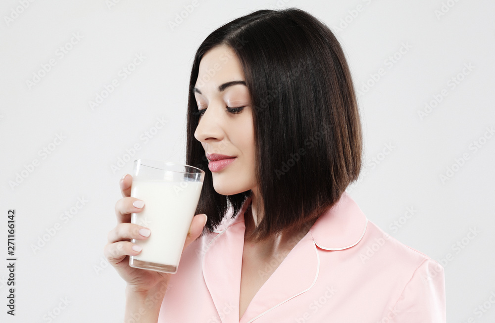 lifestyle and people concept: beautiful girl dressed in pajamas drinking milk lifestyle and people concept: beautiful girl dressed in pajamas drinking milk
