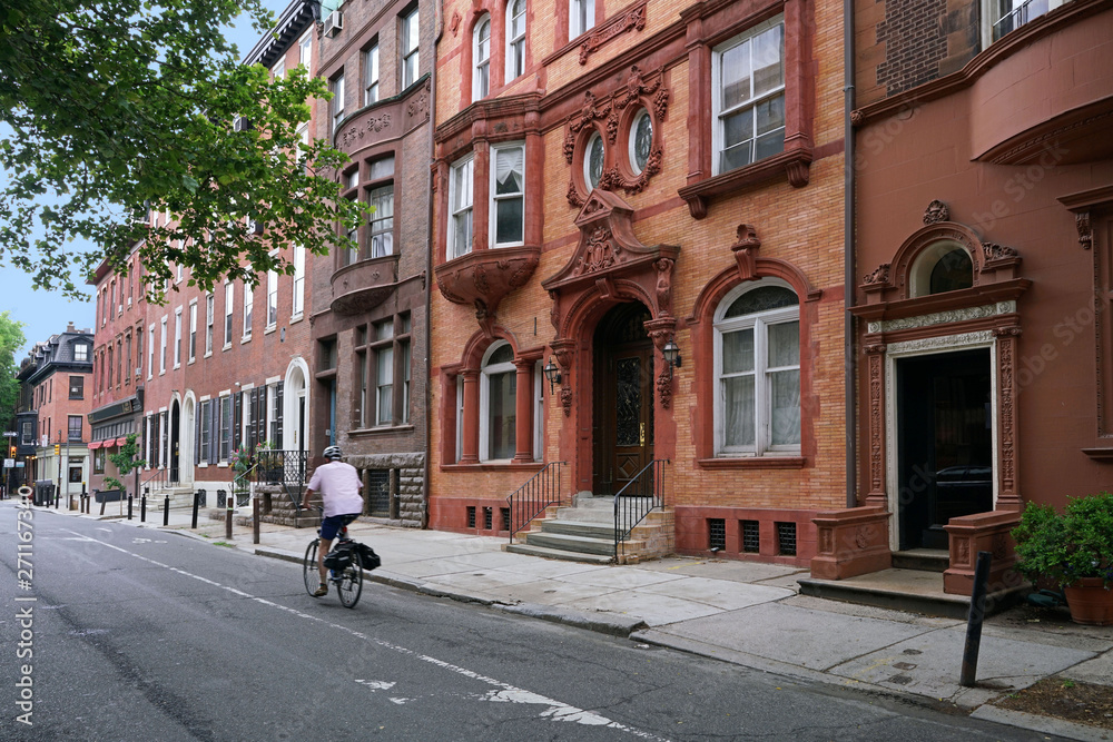 urban street with old brownstone style townhouses or apartment buildings