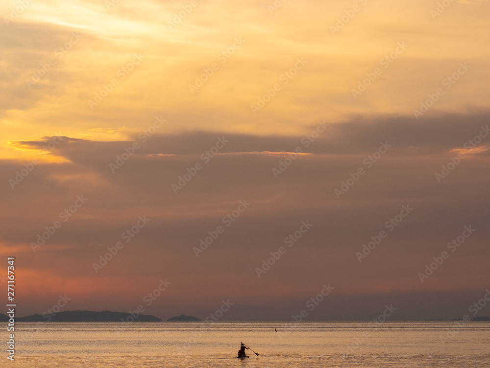 Kayak at sunset int he distance