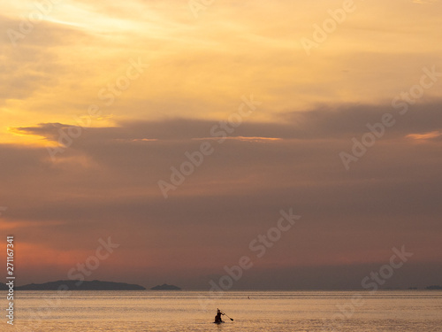 Kayak at sunset int he distance