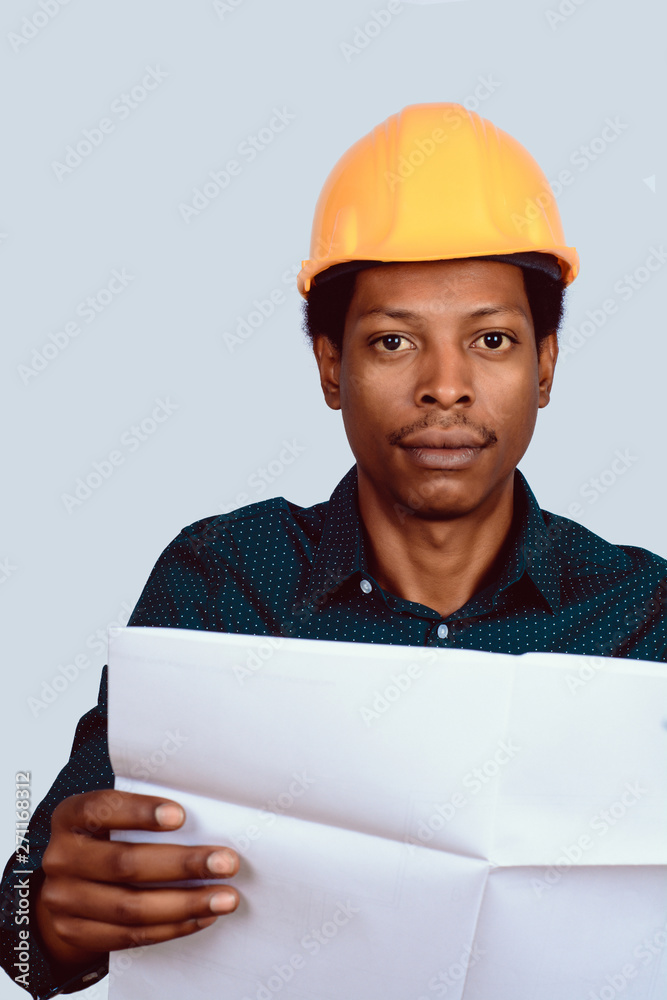 Afro american architect in hard hat with blueprint.