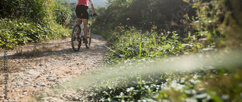 Woman cyclist riding a bike on a nature trail in the mountains.people living a healthy lifestyle