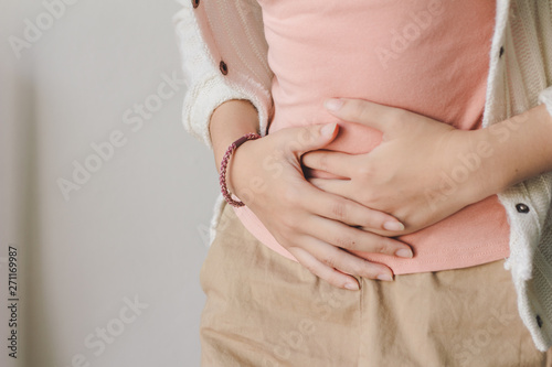 Young woman suffering from abdominal pain. Menstrual pain. photo