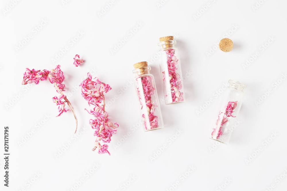 small glass bottles and dried hyacinth flowers. view from above, flat lay small glass bottles and dried hyacinth flowers. view from above, flat lay