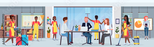 janitors team african amerian cleaners in uniform working together with professional equipment cleaning service concept creative co-working center modern office interior flat full length horizontal
