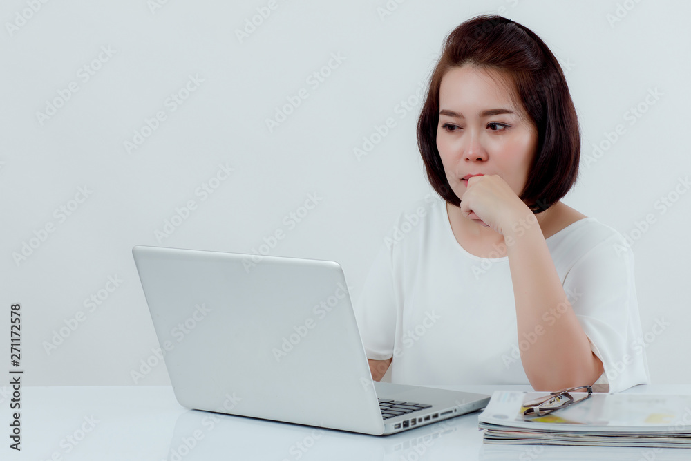 Asian beautiful woman Sitting in a white shirt On the front desk, there is a laptop computer placed. Expression There is work stress. With a white background Asian beautiful woman Sitting in a white shirt On the front desk, there is a laptop computer placed. Expression There is work stress. With a white background