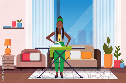 housewife ironing clothes african american woman using iron girl doing housework concept modern living room interior female cartoon character full length flat horizontal
