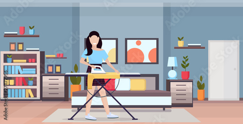 housewife ironing clothes young woman holding iron smiling girl doing housework concept modern bedroom interior female cartoon character full length flat horizontal vector illustration