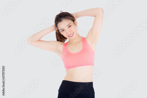 Beautiful portrait young asian woman standing stretch muscle arm isolated on white background  girl wear sport clothes exercise and yoga for health  wellness concept.
