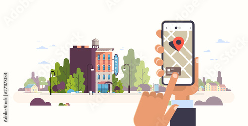 hand holding smartphone hotel booking concept hostel building exterior mobile app gps searching point on city map cityscape background flat horizontal banner