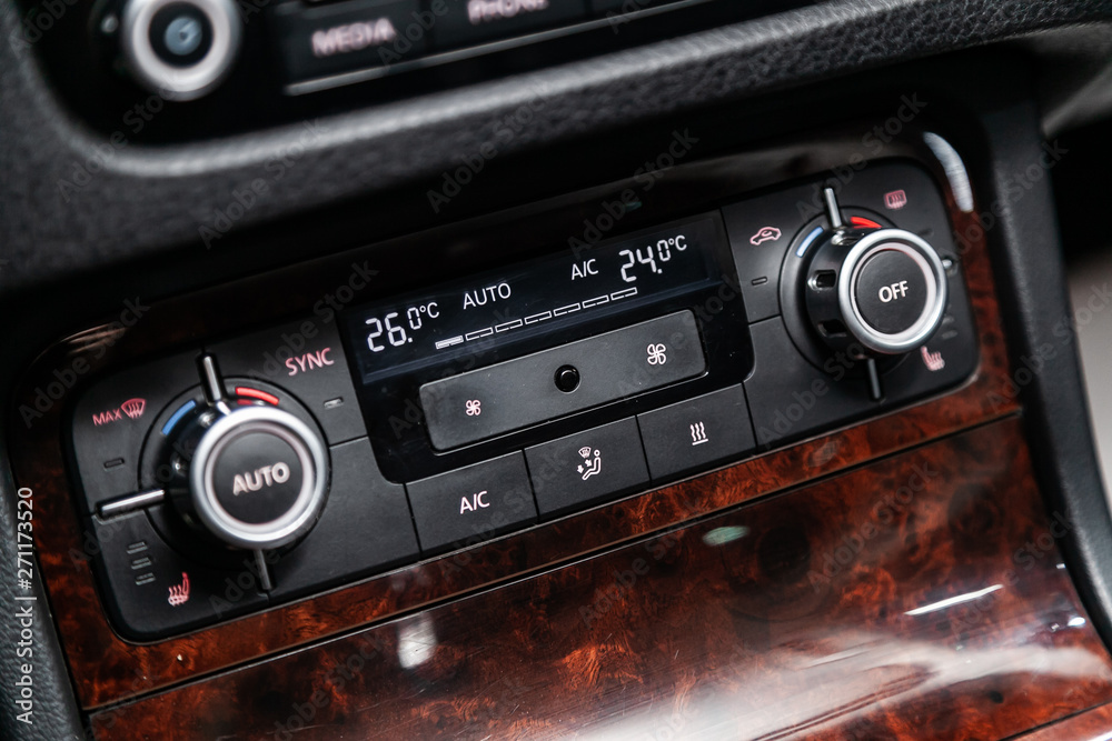 Fototapeta premium Сlose-up of the car black interior: seat heatting buttons, adjustment of the blower, air conditioner and other buttons.