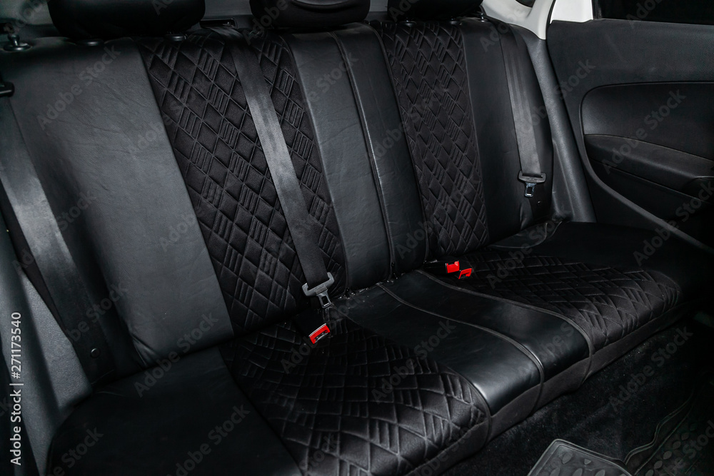 Сlose-up of the car interior: black rear seats and seat belts . Сlose-up of the car interior: black rear seats and seat belts .