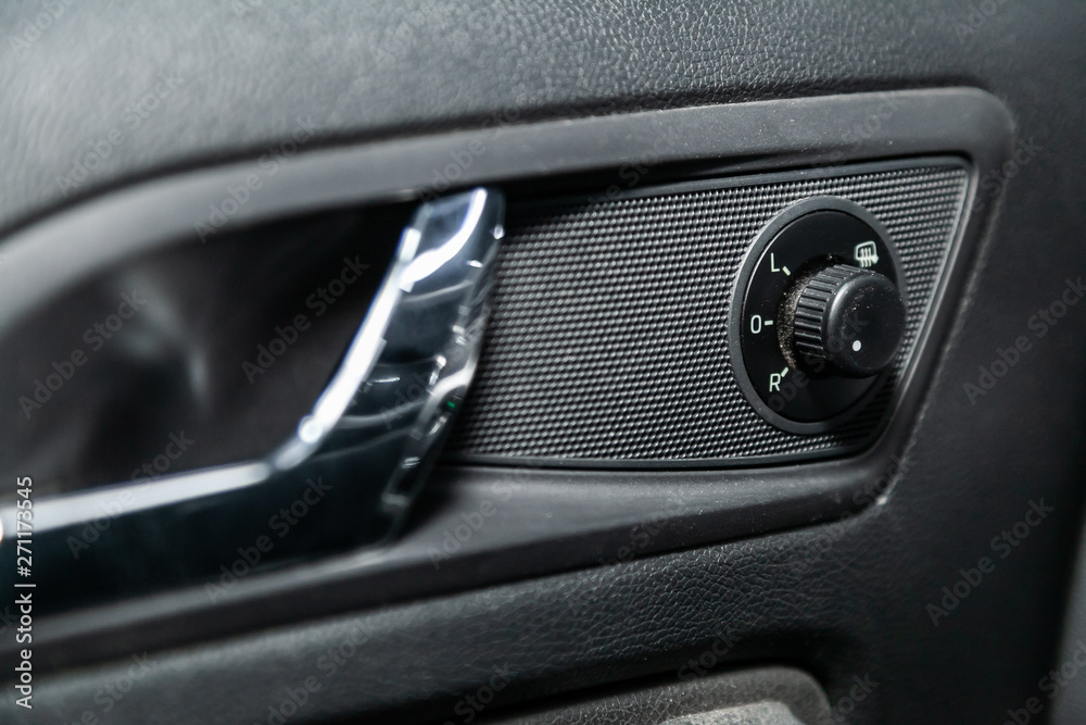 Interior design of the modern car: window adjustment buttons, door lock. luxury prestige car interior.