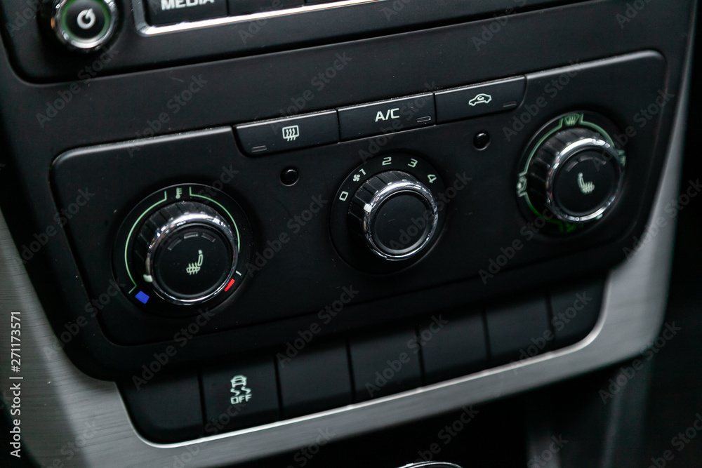 Сlose-up of the car black interior: seat heatting buttons, adjustment of the blower, air conditioner and other buttons. Сlose-up of the car black interior: seat heatting buttons, adjustment of the blower, air conditioner and other buttons.